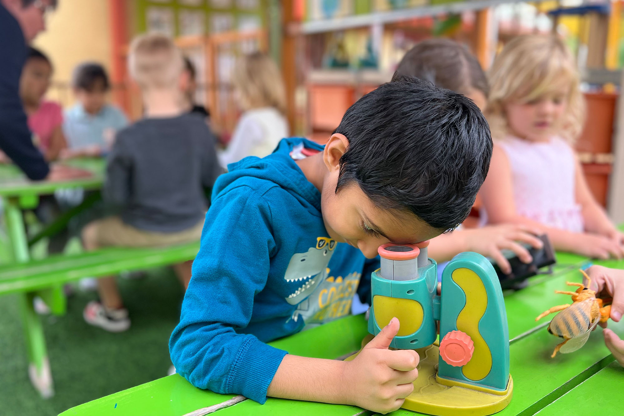 Children engaged in hands-on themed learning activities centered on discovery, science, and exploration at Academy on the Hills