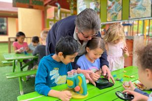 Teacher giving one-on-one attention to a child at Academy on the Hills