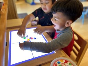 Preschool children at Academy on the Hills exploring hands-on STEAM science and engineering projects