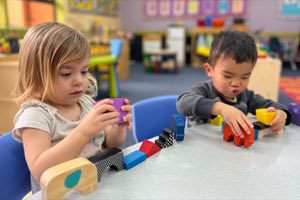 Toddlers at Academy on the Hills, ages 18 to 30 months, engaged in hands-on play-based learning